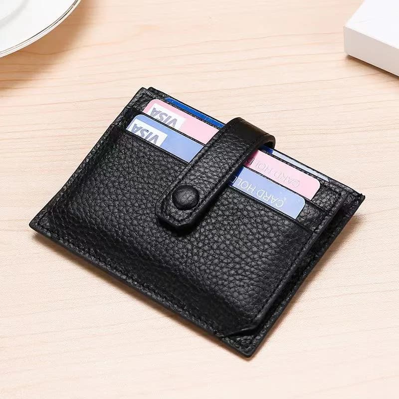 Black snap-closure leather card holder filled with cards