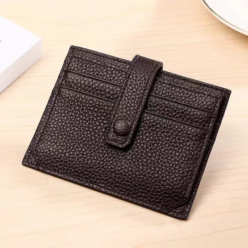 Open black leather card holder showing the card slots and snap tab