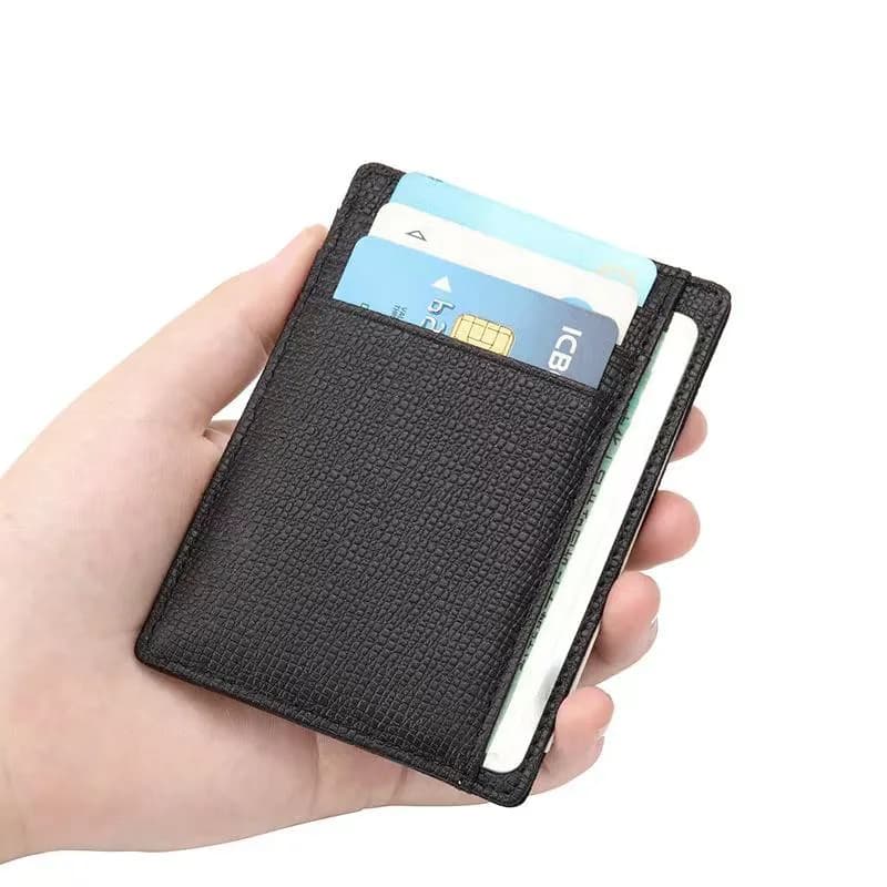 Black cowhide ID card holder held in one hand