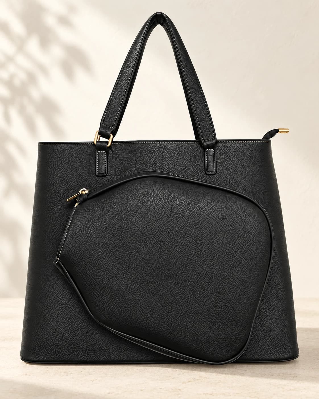 Retouched black Court Lifestyle Tote sample with curved front pouch