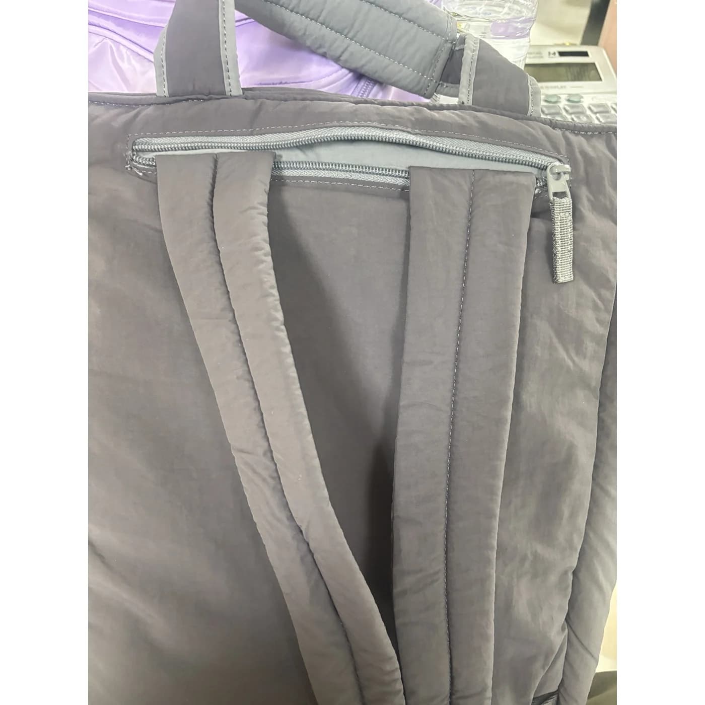 Actual PDB001 sample rear zipper pocket and strap attachment details