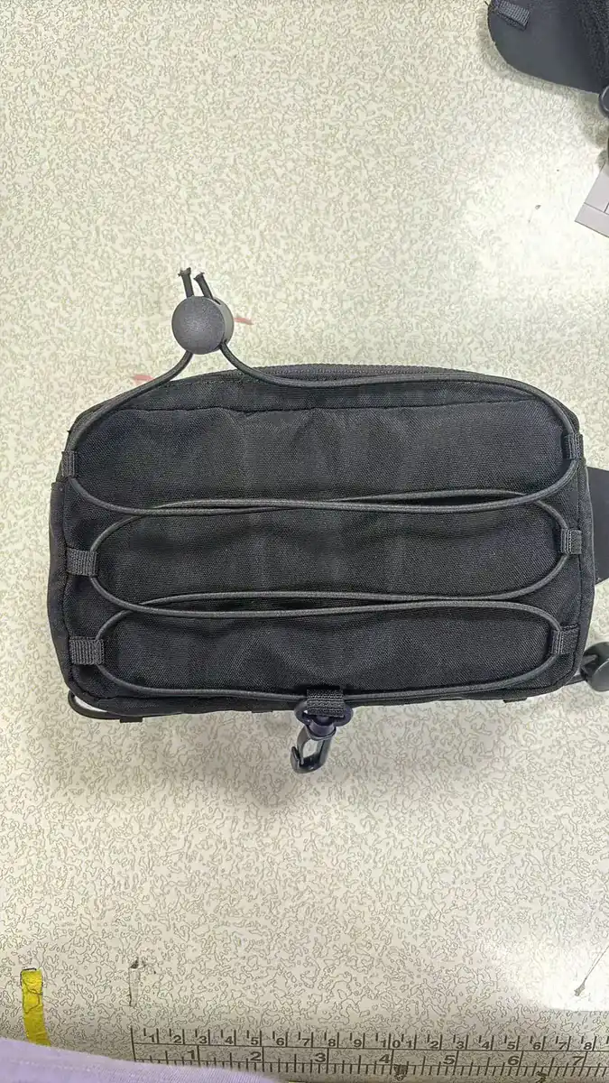 Actual black running waist pack sample front with bungee storage